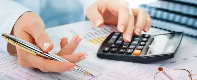 Business owner reviewing financial statements with an accountant while learning essential accounting terms for business management