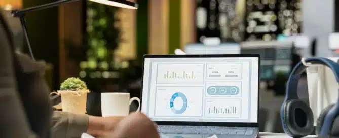 Business owner reviewing monthly financial reports and performance dashboards with an accountant in a modern office