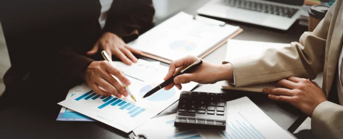 A professional consulting a business owner about financial strategy and growth opportunities.