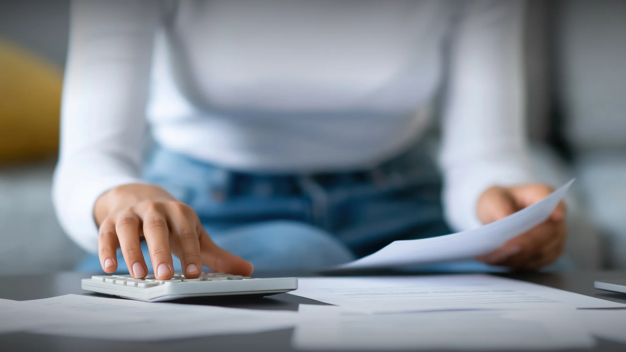 A person reviews their daily income and expenses on a tablet, ensuring strong financial control.
