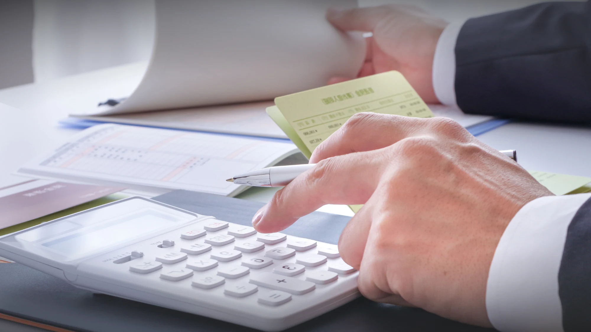Two financial professionals, a CPA and a bookkeeper, collaborating on business documents.