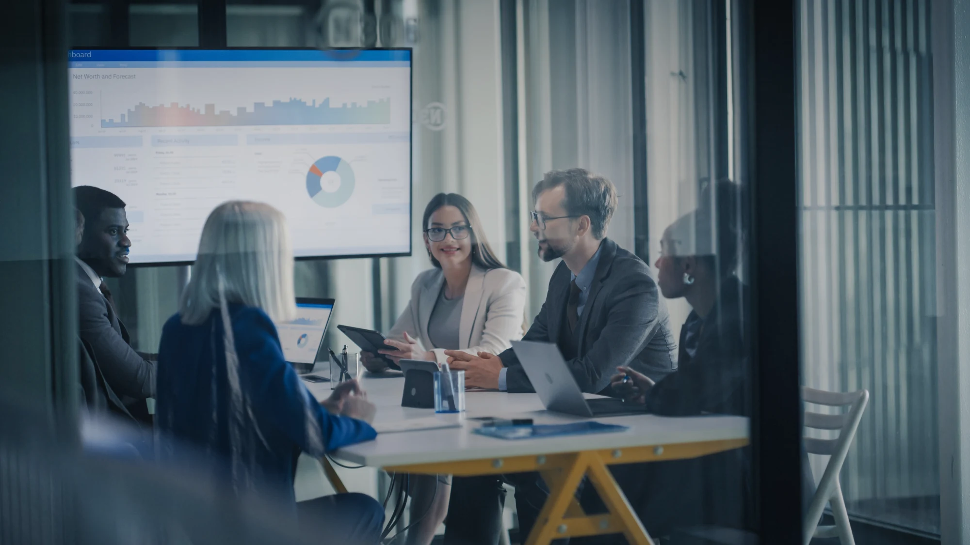 A diverse team collaborating productively in a modern, streamlined office environment.